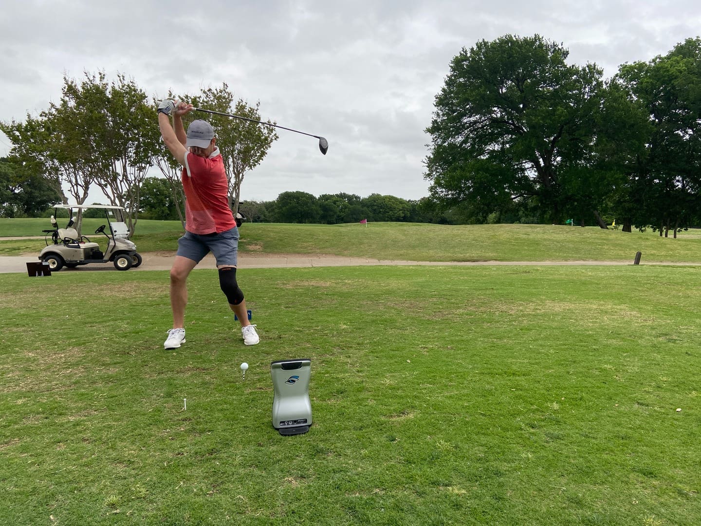 person playing golf in mid-swing
