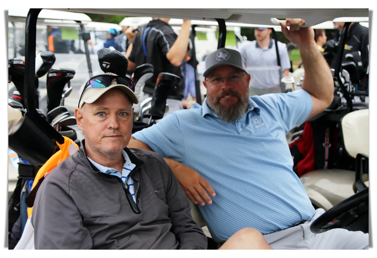 closeup of two people in a golf cart