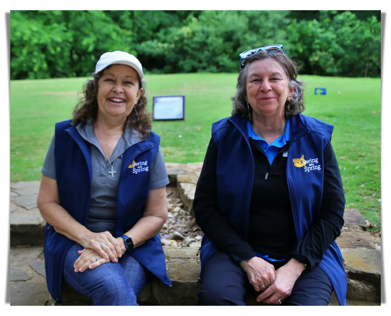 two older women at a golf course wearing blue
