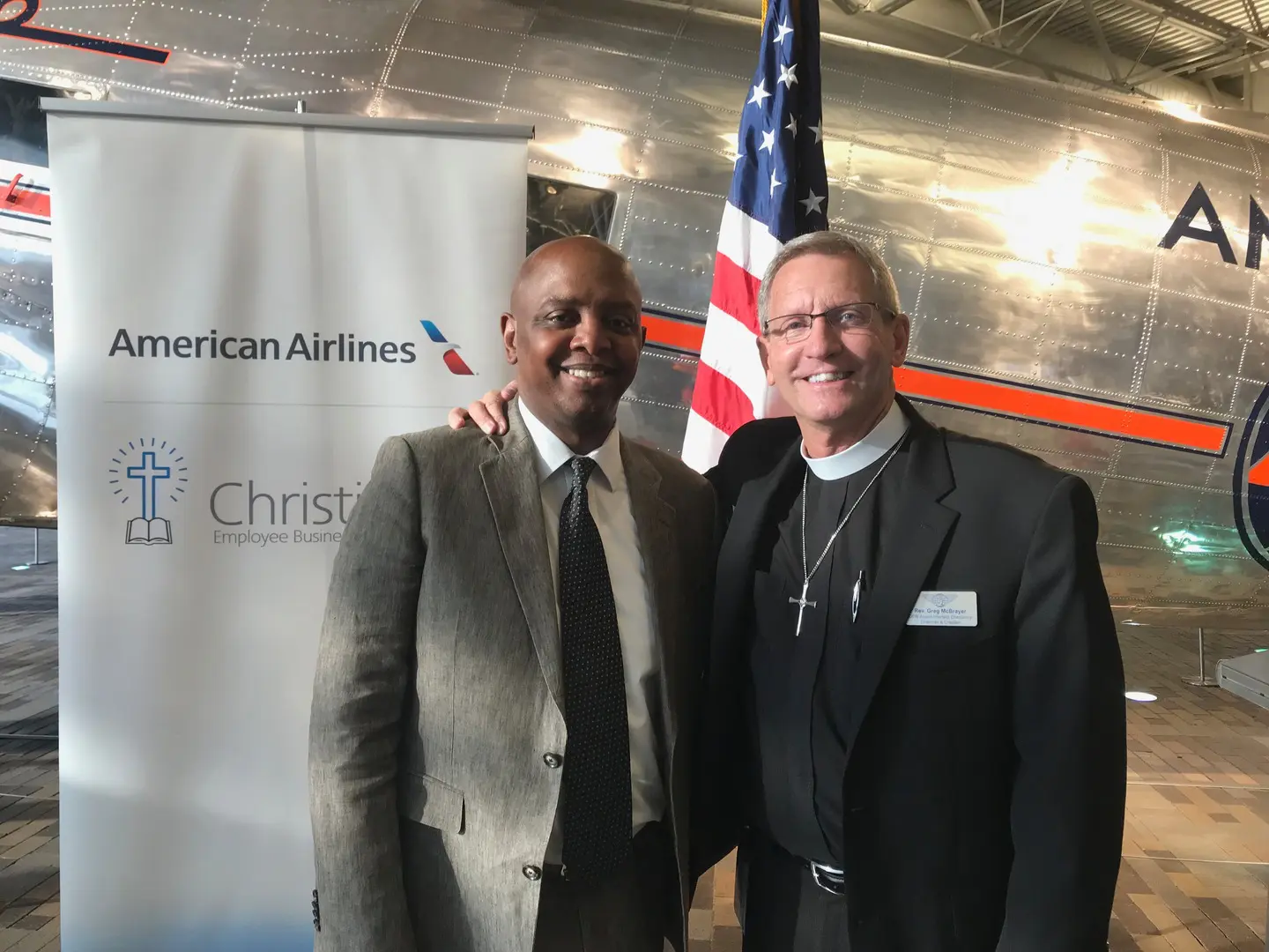 American Airlines tarp with Reverend and person wearing coats