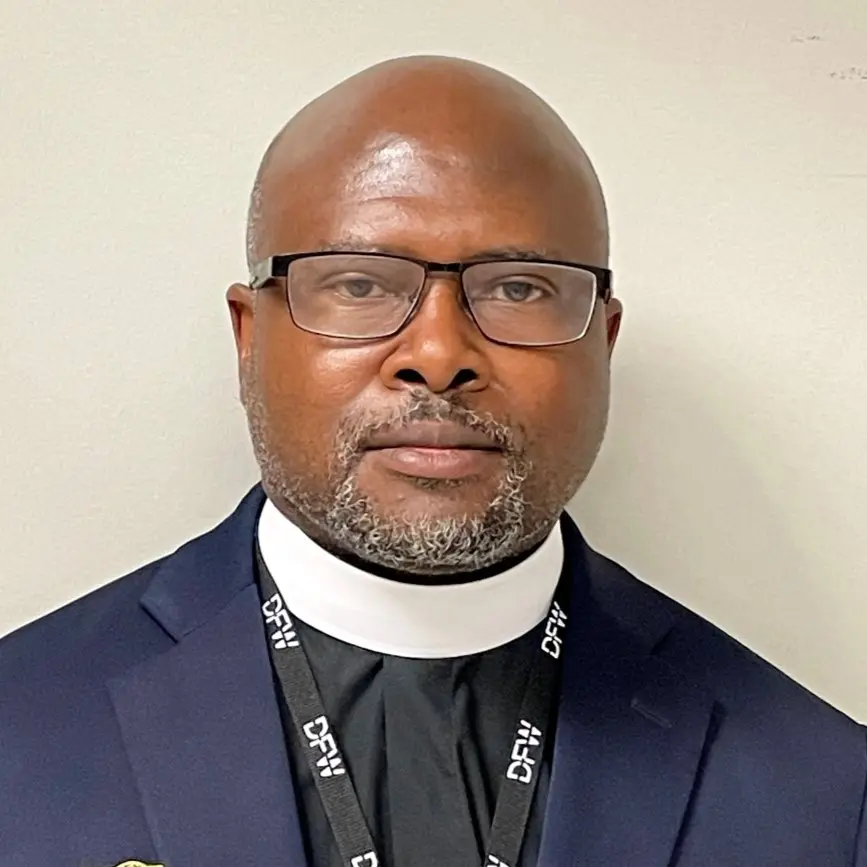 Man in suit and glasses looking at camera.