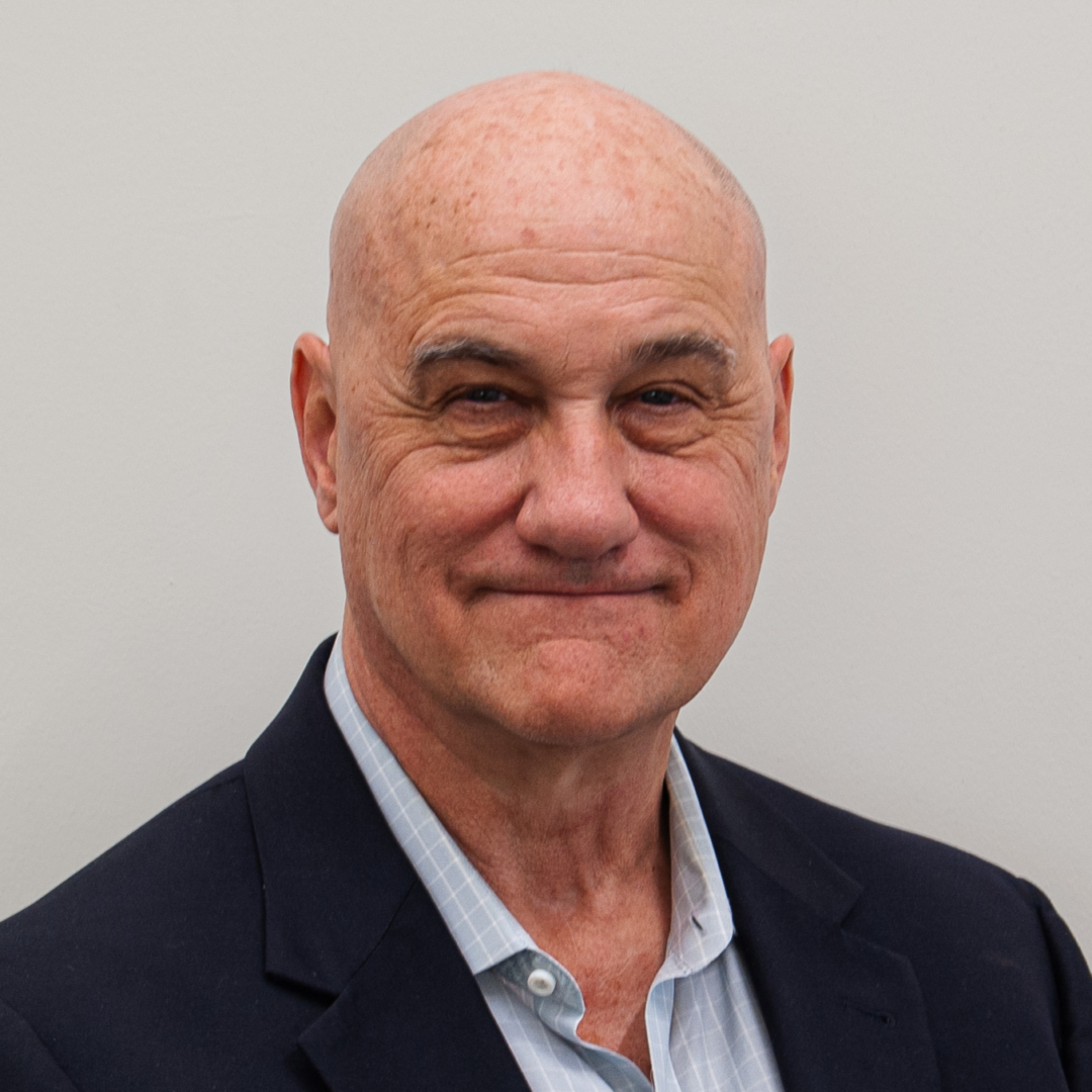 Smiling man in a suit and shirt.