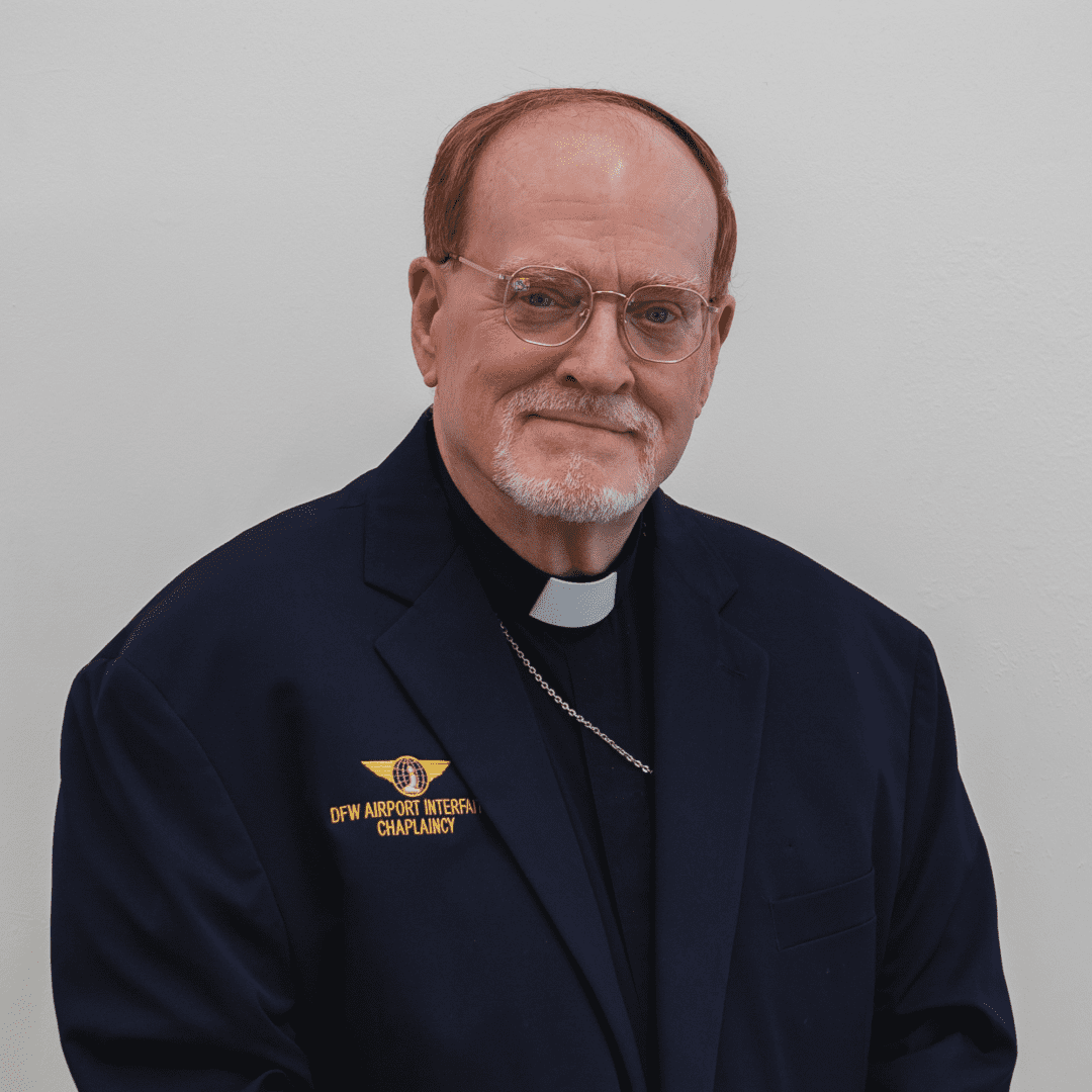 Man in suit with DFW Airport Chaplaincy patch.